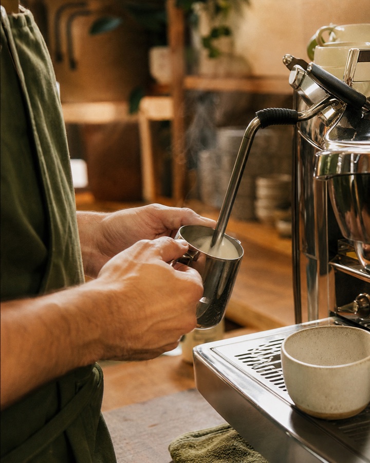 Illustrative cafe Instagram post showing a barista preparing coffee